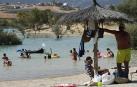 Varias personas se alivian del calor en el pantano de Alloz y en el río Arga a su paso por Irotz.