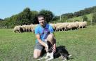Julen Arburua Jiménez, con uno de sus perros, y parte de su rebaño, en Lekaroz.