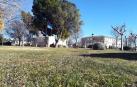 Terrenos donde se hará el instituto con el colegio, al fondo.