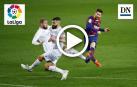 El delantero argentino del FC Barcelona, Leo Messi, golpea el balón ante los defensores del Huesca para conseguir el cuarto gol