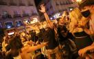 Jóvenes en Madrid celebran el final del toque de queda en la Puerta del Sol.