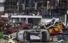 Vehículos destrozados apilados cerca de un centro comercial destruido durante un combate en Mariupol